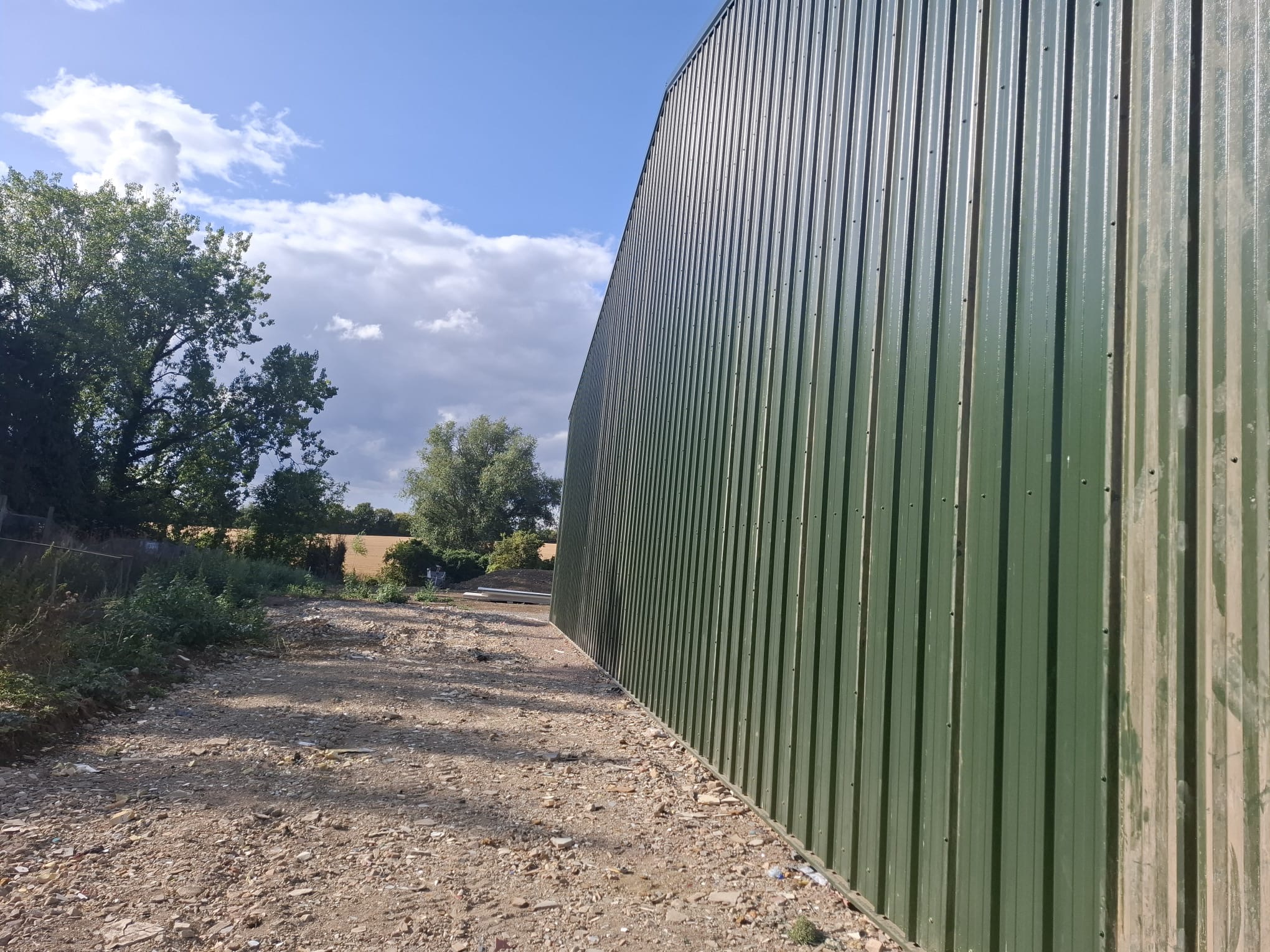 Commercial industrial building with green profiled metal cladding - DB Roofing project